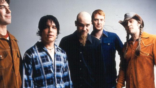 Queens of the Stone Age fans have expressed their support for the ailing frontman (second from right).