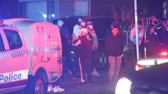 Crowds gather in Narelle Cres after last night’s shooting. Picture: TNV