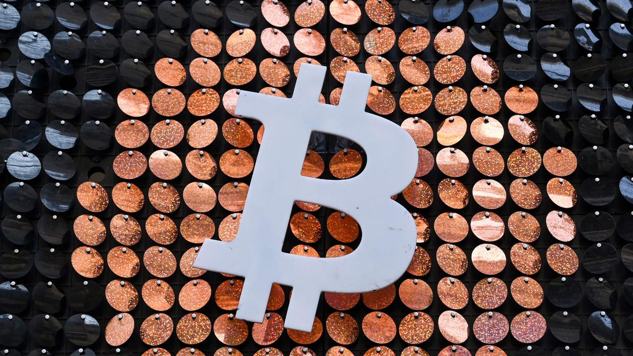 The logo of Bitcoin digital currency outside an ATM in France. Picture: AFP.