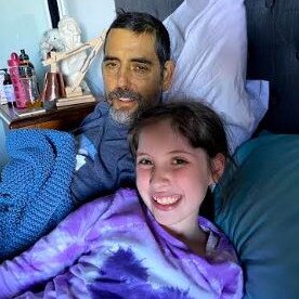 Dean Varley, 49, with his daughter Louisa, 8, at their Tumbi Umbi home where he is receiving palliative care for terminal stage four bowel cancer. Picture: Supplied