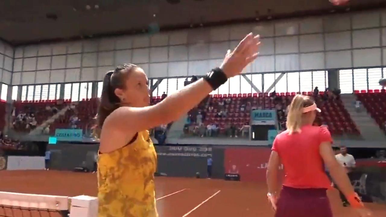 Daria Kasatkina shakes hands with the umpire after Lesia Tsurenko walks past her.