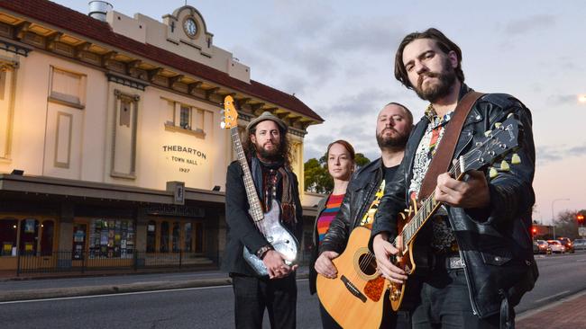 Musicians Trent Worley, Sean Kemp and Dusty Lee Stephensen with Thebby employee Amy Boman outside the Thebarton Theatre. Picture: Brenton Edwards