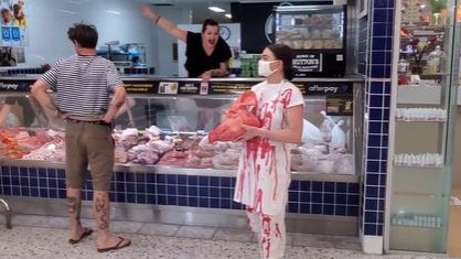 Staff at a butcher yell at Tash Peterson to leave during one of her confronting protests holding a bloody pig head. Picture: Instagram