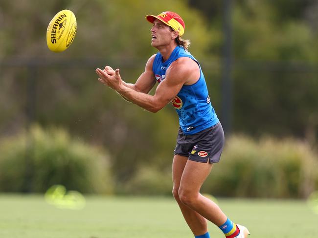 Darcy Macpherson fires a handball. Picture: Chris Hyde/Getty Images