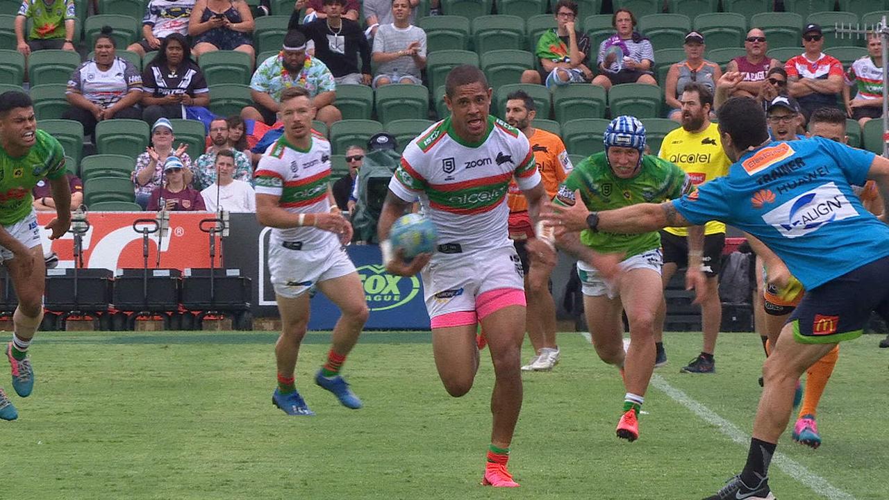 Raiders trainer Michael Ennis pretends to grab Dane Gagai as he intercepts a pass and goes on to score.