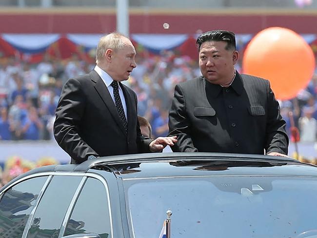 This picture taken on June 19, 2024 and released on June 20, 2024 from North Korea's official Korean Central News Agency (KCNA) via KNS shows North Korea's leader Kim Jong Un (centre R) and Russia's President Vladimir Putin (centre L) parading around in an open-top car during a welcoming ceremony at Kim Il Sung Square in Pyongyang. Putin signed a mutual defence agreement on June 19 with North Korea's Kim, who offered his "full support" on Ukraine. (Photo by KCNA VIA KNS / AFP) / - South Korea OUT / REPUBLIC OF KOREA OUT   ---EDITORS NOTE--- RESTRICTED TO EDITORIAL USE - MANDATORY CREDIT "AFP PHOTO/KCNA VIA KNS" - NO MARKETING NO ADVERTISING CAMPAIGNS - DISTRIBUTED AS A SERVICE TO CLIENTS THIS PICTURE WAS MADE AVAILABLE BY A THIRD PARTY. AFP CAN NOT INDEPENDENTLY VERIFY THE AUTHENTICITY, LOCATION, DATE AND CONTENT OF THIS IMAGE. THIS PHOTO IS DISTRIBUTED EXACTLY AS RECEIVED BY AFP. /