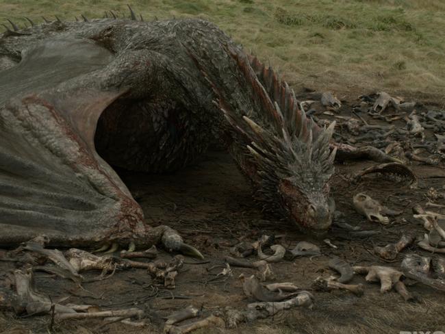 A Game of Thrones dragon sits on a hoard of bones. While fearful, dragons represent natural threats we understand and can deal with. Picture: HBO/Game of Thrones