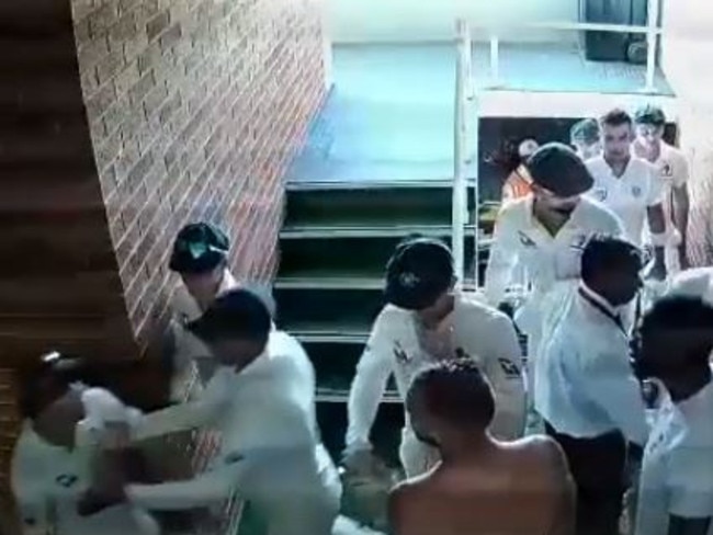 David Warner being restrained by teammates in the Durban stairwell.