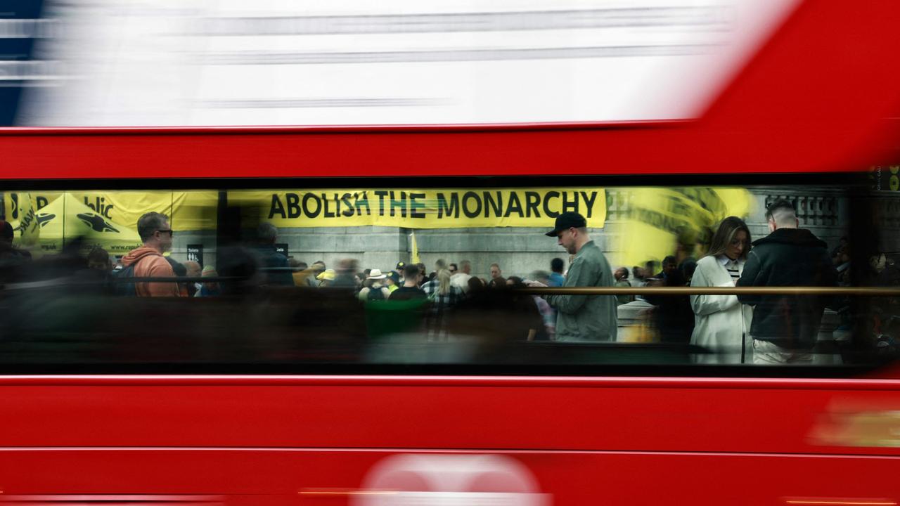 Members of the anti-monarchist group Republic are seen through the windows of a London bus as they stage a protest in Trafalgar Square in central London. Picture: Benjamin Cremel/AFP