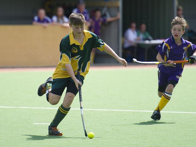 Macarthur Chronicle - Pictured: Dylan Offord (Harrington Park) chases the ball - Ingleburn Bulldogs (green yellow) versus Harrington Park Hurricanes (purple) - Macarthur District Juniors hockey finals 2014 held at Millwood Avenue, Narellan NSW Australia