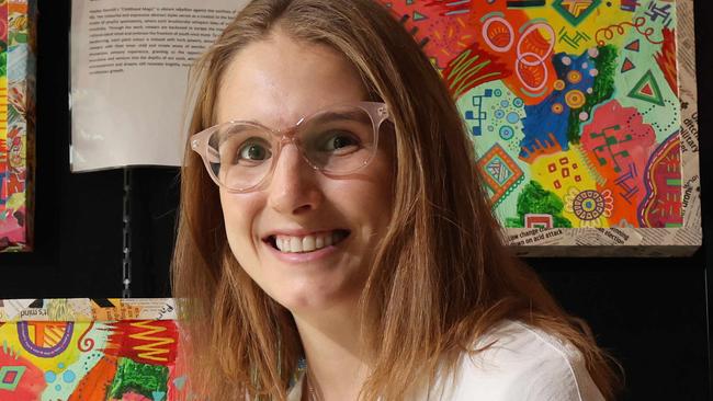 Local artist Hayley Stanich in front of some her work on display in Robina Hospital as part of Artbeat. Art Beat is a mental health initiative using painting as therapy. Picture Glenn Hampson