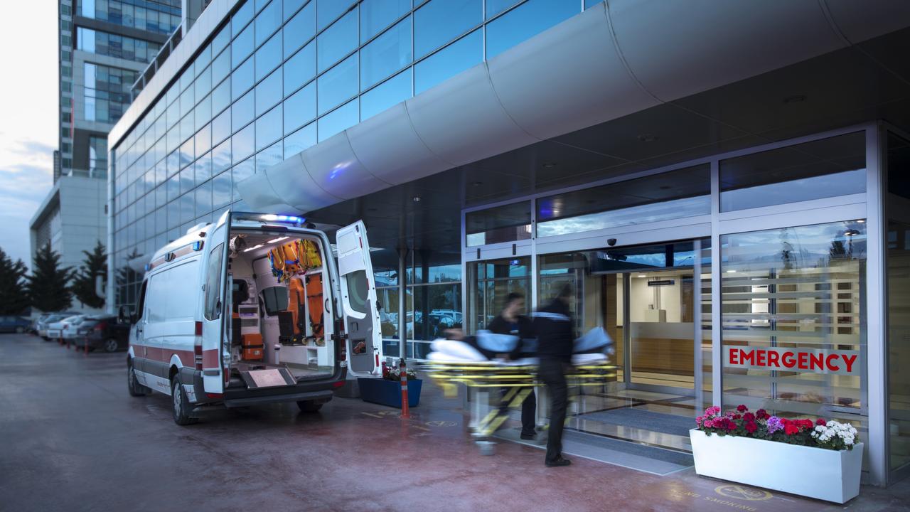 Paramedics taking patient on stretcher from ambulance to hospital - picture istock