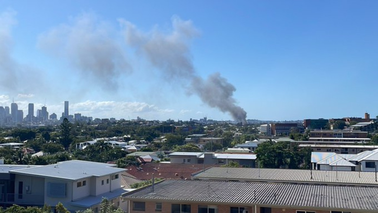 Smoke seen rising from the fire that has affected two houses in Norman Park. Picture: Twitter/@Scotty_McDonald