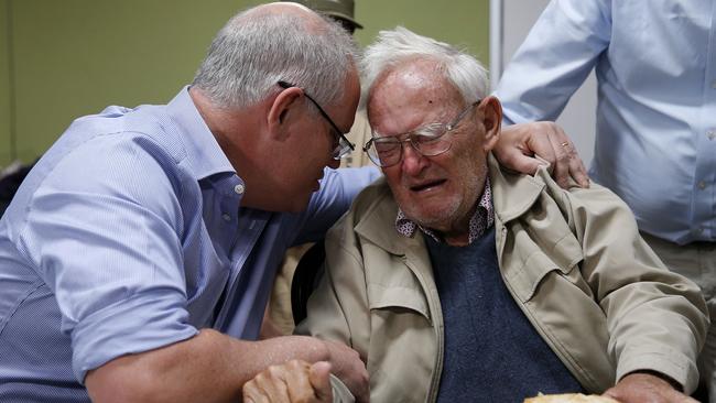 Prime Minister Scott Morrison is seen comforting 85-year-old Owen Whalan at an evacuation centre in Taree. Picture: AAP