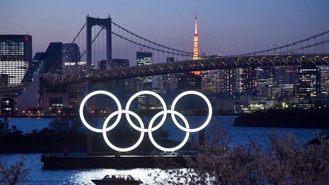 A boat sails past the Tokyo 2020 Olympic Rings on March 25