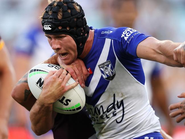 SYDNEY, AUSTRALIA - MARCH 20:  Matt Burton of the Bulldogs is tackled during the round two NRL match between the Canterbury Bulldogs and the Brisbane Broncos at Accor Stadium, on March 20, 2022, in Sydney, Australia. (Photo by Mark Kolbe/Getty Images)