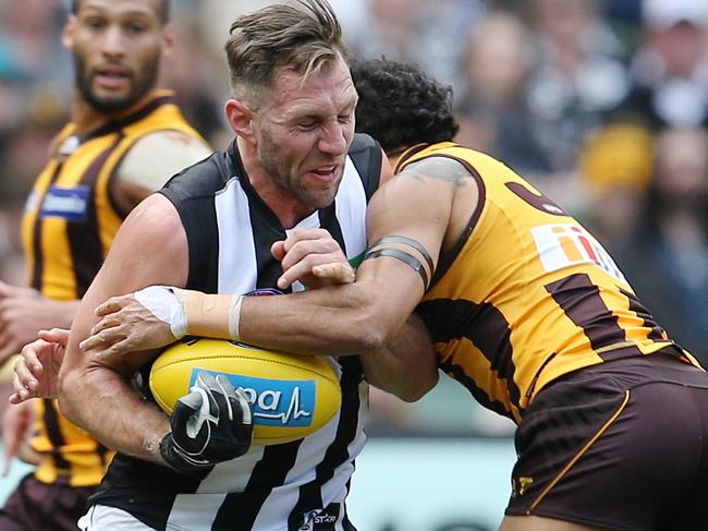 Hawthorn vs Collingwood at the MCG. Travis Cloke tries to smash through the Cyril Rioli tackle . Pic: Michael Klein