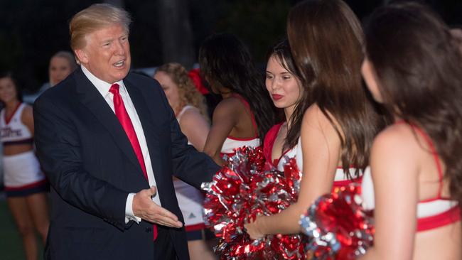 US President Donald Trump greets cheerleaders at his Super Bowl party. Picture: AFP.