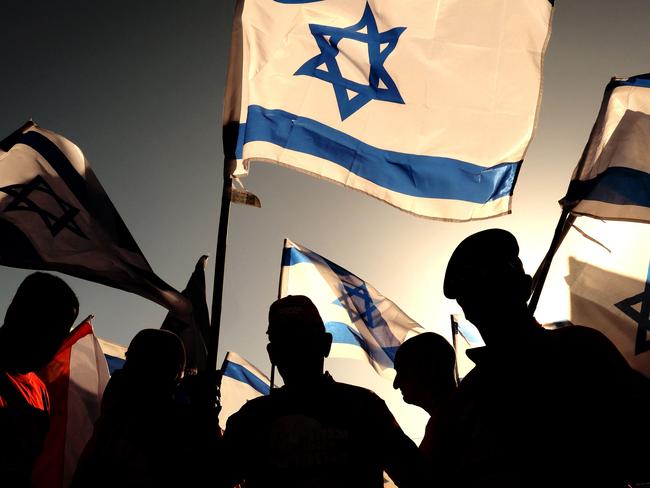 Israeli military veterans wave national flags at a rally against the government's judicial reform bill. Picture: AFP.