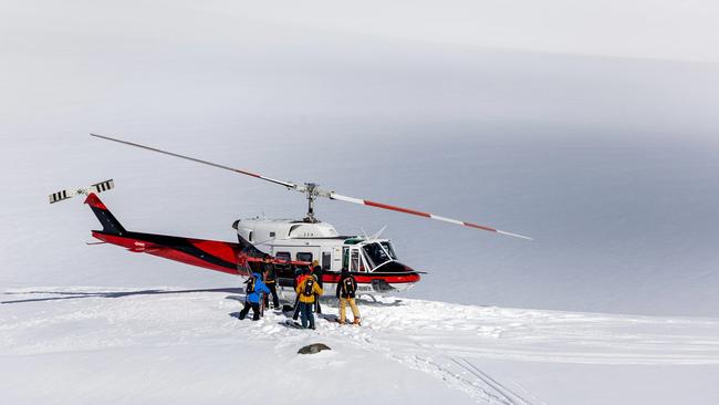 Skiers disembark from a CMH chopper in the Purcell Mountains.