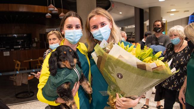 Olympians Kaylee McKeown and Ariarne Titmus on their return home at Brisbane Airport. (Picture: Brad Fleet)