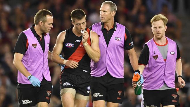 Zach Merrett is helped from the field by trainers. Picture: Getty Images