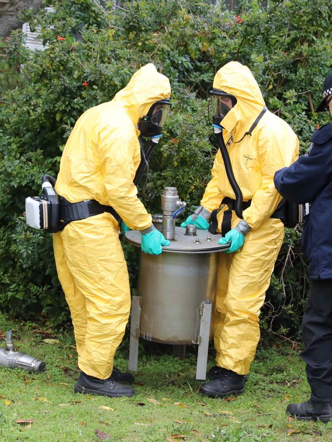 Detectives remove sophisticated drug production equipment from an alleged clandestine drug laboratory, uncovered at Morphett Vale. Picture Dean Martin.