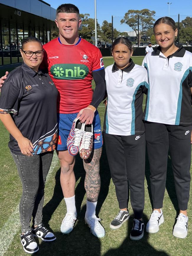 Lehetta Lane-Porter with Bradman Best after he was surprised with Indigenous-designed boots for Saturday's game against the Cronulla Sharks.