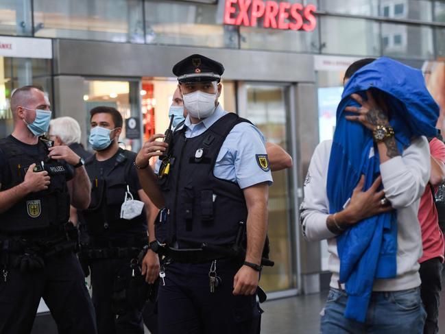 Police patrol a railway station in the German city of Dortmund to make sure citizens were wearing masks. Picture: AFP