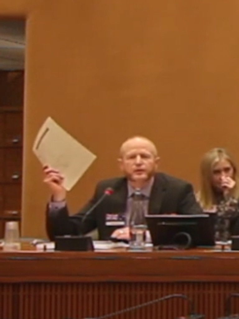 Dr Damian Adams holds up his original birth certificate during his statement to the 30th anniversary of the United Nations Convention on the Rights of the Child in Geneva in 2019.