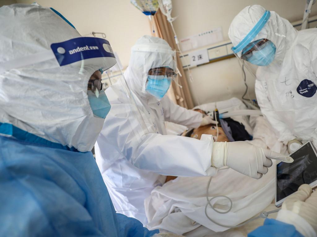 A doctor checks a patient who is infected by the COVID-19 coronavirus at the Wuhan Red Cross Hospital in Wuhan. Picture: STR/AFP