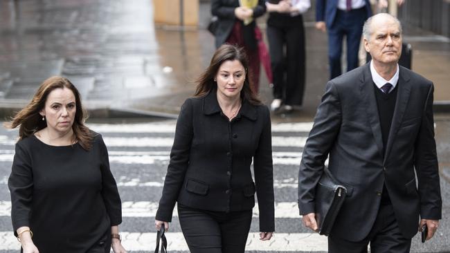 Former Super Retail executive-turned-whistleblower Rebecca Farrell and fellow former executive and whistleblower Amelia Berczelly with lawyer Michael Harmer.