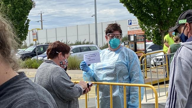 Shepparton Hospital staff were encouraging people in the testing queue to dial a hotline and preregister their details. Picture: Madi Chwasta