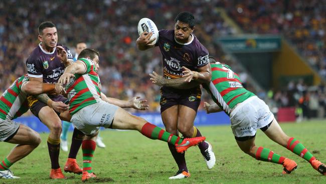 Souths’ Paul Carter trips Brisbane’s Anthony Milford. Picture: Darren England