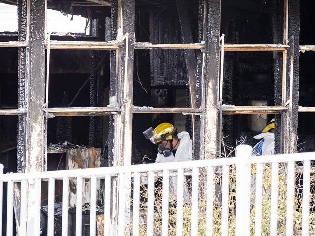 Police and fire investigators at the site of the overnight fire at Cosgrove High School. Picture: RICHARD JUPE