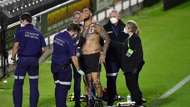 Paramedics attend to Andrew Fifita (C) after suffering a throat injury against the Knights. Picture: AAP/Darren England