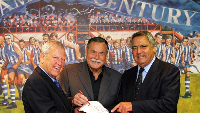 Allen Aylett, Ron Barassi and Albert Mantello with the dinner napkin contract that paved the way to glory.