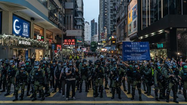 Riot police put up a warning flag during an anti-government protest on Sunday in Hong Kong. Picture: Getty Images