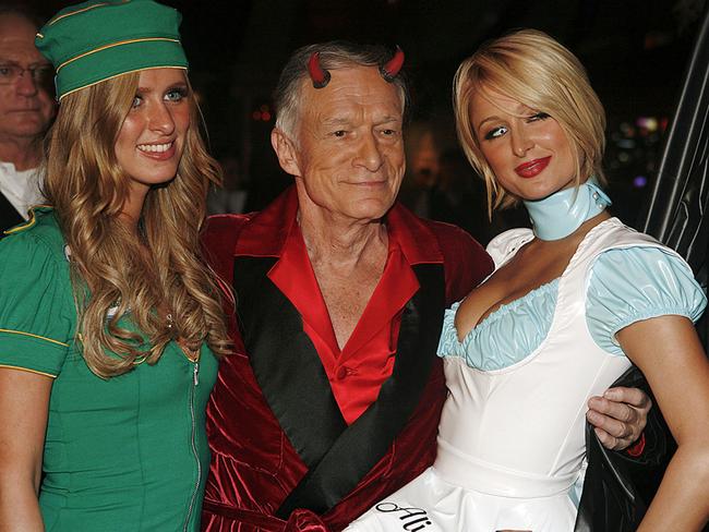 Hugh Hefner poses with Nicky and Paris Hilton during Playboy’s annual Halloween party in Los Angeles, 27/10/2007. Picture: Playboy