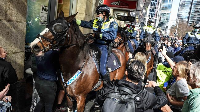 Police officers on horseback disperse protesters during the rally in Sydney. Picture: NCA NewsWire/Flavio Brancaleone