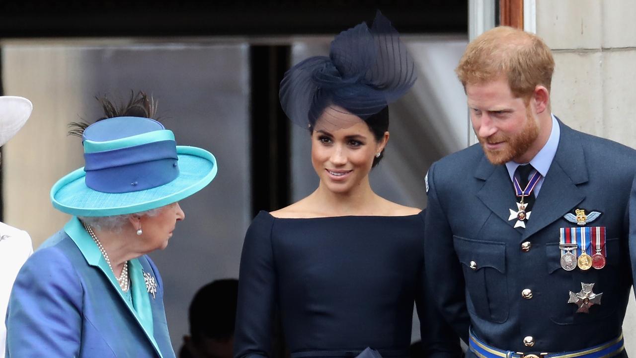 Queen Elizabeth II, Meghan, Duchess of Sussex, Prince Harry, Duke of Sussex watch the RAF fly-past on the balcony of Buckingham Palace. Picture: Getty Images)