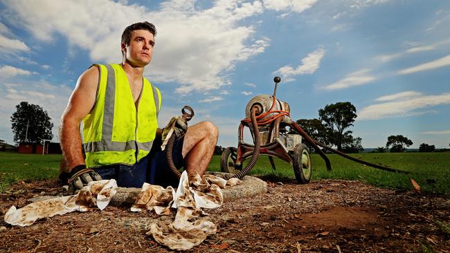 Andrew Nicol from BDC Plumbing, pictured at Greystanes removing wet wipes from a drain. Makers of “flushable” wet wipes are facing a lawsuit from Australia’s consumer watchdog.