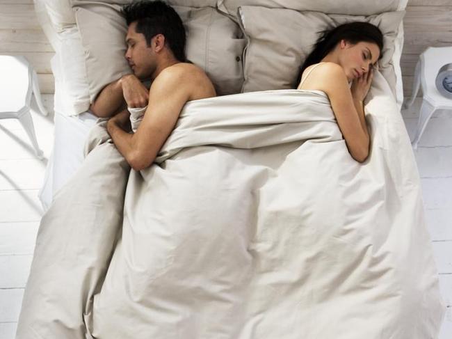 Couple Sleeping on Opposite Sides of Bed