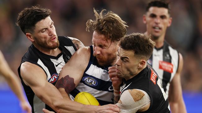 MELBOURNE, AUSTRALIA - Augus 11 , 2023. AFL .      Zach Tuohy of the Cats gets tackled by Jamie Elliott and Jack Crisp of the Magpies during the round 22 match between Collingwood and Geelong at the MCG in Melbourne.   Photo by Michael Klein.