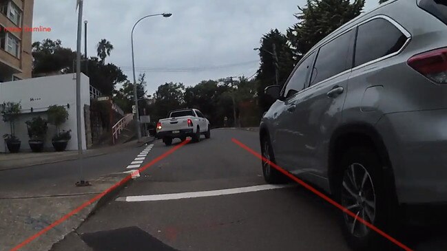 Dashcam footage showing a close call between a bike and car on a Sydney road.