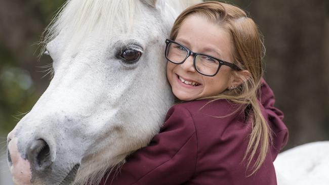 Pandora Humphries, now 13, with her beloved pony. Picture: Jason Edwards