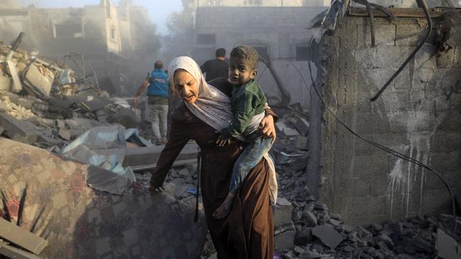 People flee following Israeli air strikes on a neighbourhood in the al-Maghazi refugee camp in the central Gaza Strip. Picture: AFP