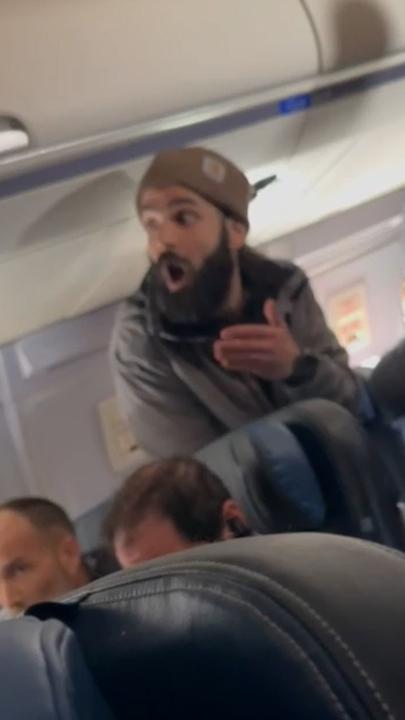 A crazed passenger attempted to stab a flight attendant and open the emergency hatch