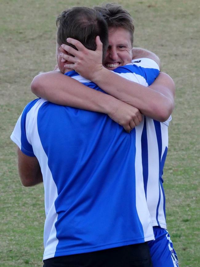 Langwarrin co-coaches Josh Beard (left) and Blake McCormack embrace after their side's one-point win over Chelsea.