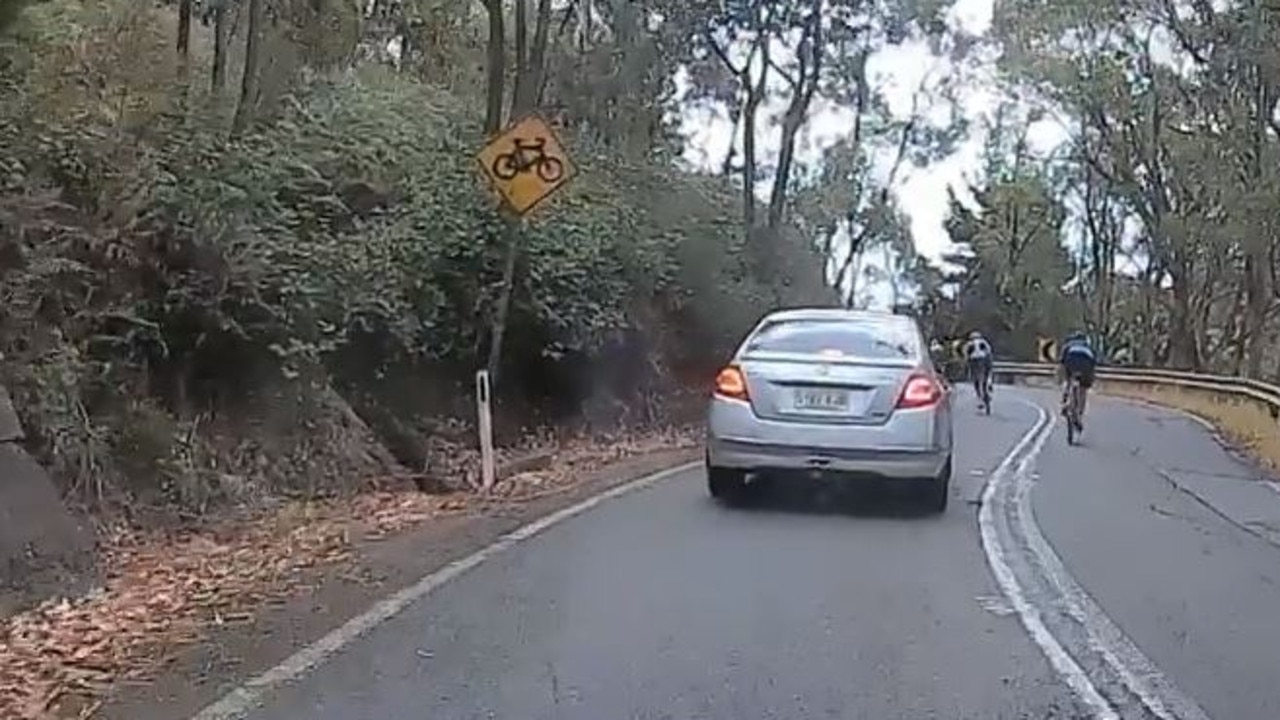 Screen grab of cyclists overtaking cars on a single-lane mountain path along Greenhill Road, Adelaide, South Australia.